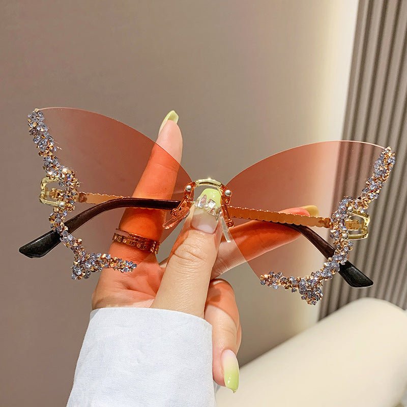Butterfly-shaped sparkling rhinestone-rimmed sunglasses