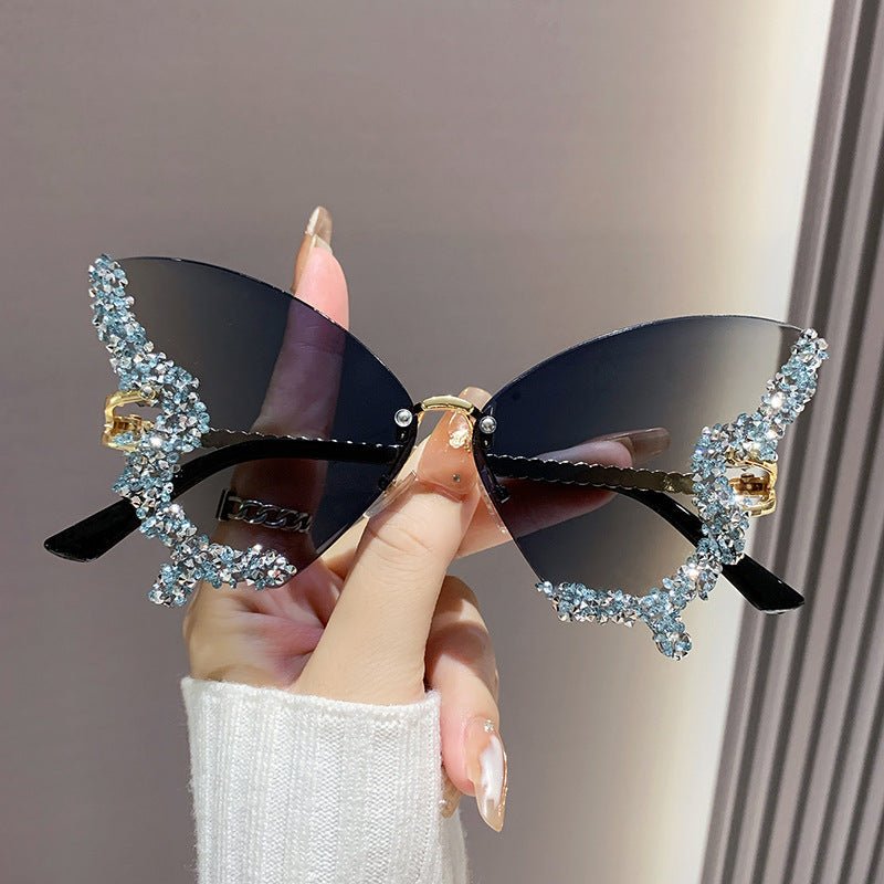 Butterfly-shaped sparkling rhinestone-rimmed sunglasses